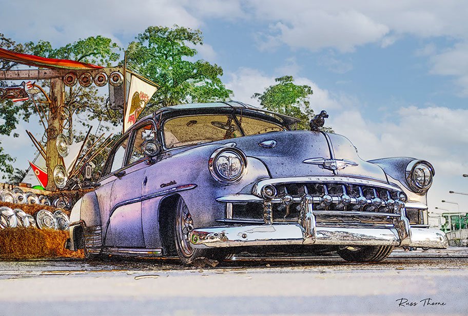A beautifully fully restored 1940s Chevrolet sedan on display at a car show, reflecting its vintage elegance.